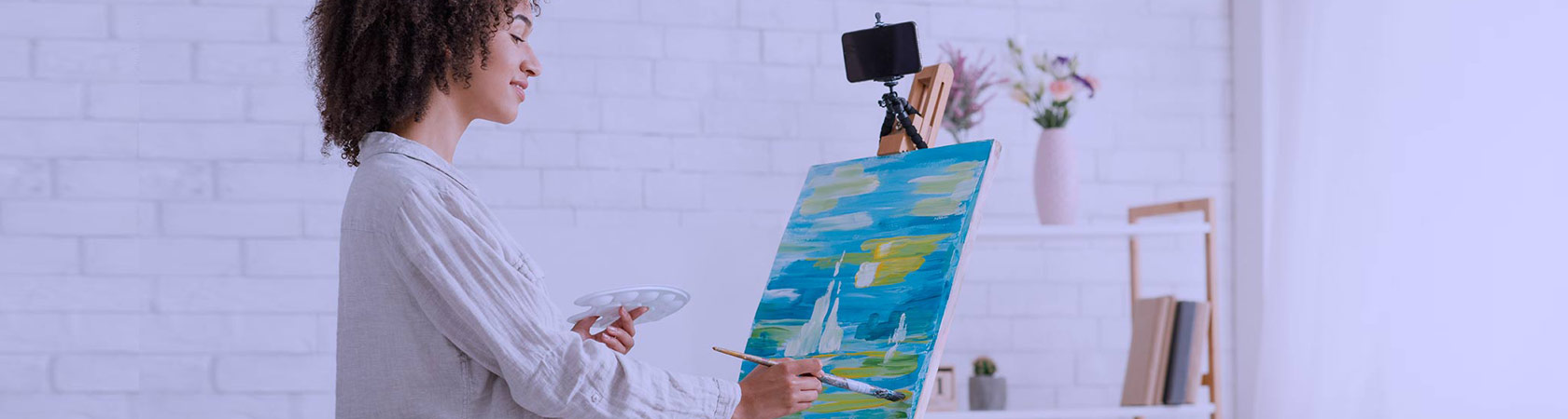 woman painting while she's streaming live on social
